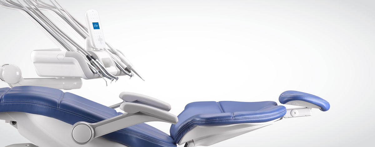 Profile view of A-dec 500 dental chair with blue upholstery and an A-dec 500 Continental delivery system on a white background